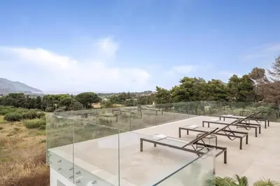 a group of tables on a glass roof with trees at Historic Villa Overlooking Scopello Sea Stacks in Castellammare del Golfo