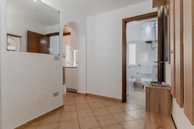 a hallway with a bathroom with a toilet and a mirror at GuestHost - Don Pippo Flat near Teatro Massimo in Palermo