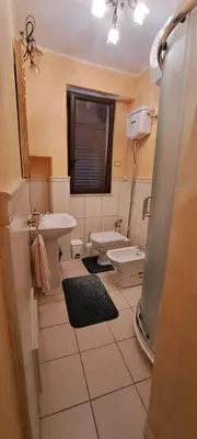 a bathroom with a sink and a toilet at Casa Mazzini in Carini
