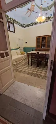 a view of a living room with a dining room table at Casa Mazzini in Carini