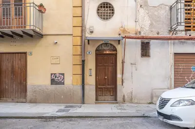 a building with a wooden door on a street at Gorizia Apartment by Wonderful Italy in Palermo