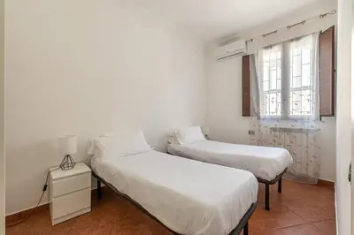 two beds in a white room with a window at Gorizia Apartment by Wonderful Italy in Palermo