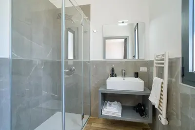 a bathroom with a shower and a sink at Ella Suites Apartments in Terrasini