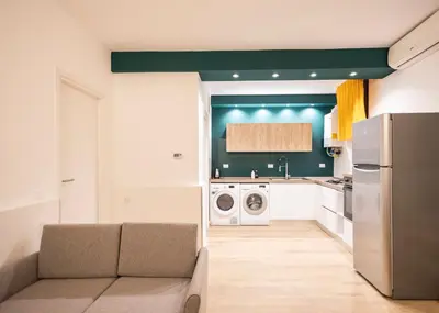 a kitchen with a couch in a kitchen with a refrigerator at Flat in Center in Palermo