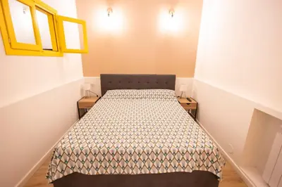 a small bedroom with a bed in a room at Flat in Center in Palermo