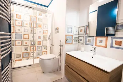 a bathroom with a white toilet and a sink at Flat in Center in Palermo
