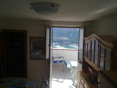 a room with a door open to a balcony at Angolo di CIELO in Castellammare del Golfo
