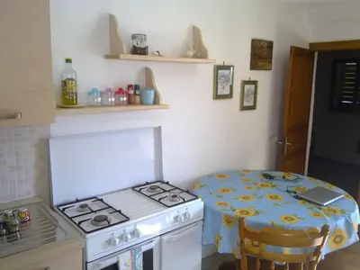 a small kitchen with a stove and a table at Angolo di CIELO in Castellammare del Golfo