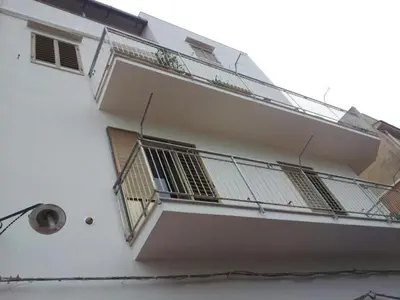 a white building with a balcony and a window at Angolo di CIELO in Castellammare del Golfo