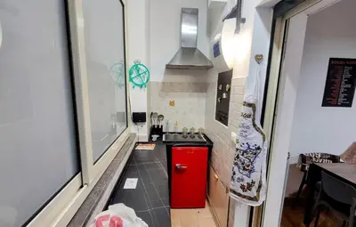 a small kitchen with a red refrigerator and a stove at Roccaforte House - Palermo in Palermo