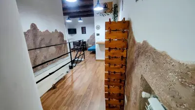 a staircase in a room with wooden floors and a wall at Roccaforte House - Palermo in Palermo