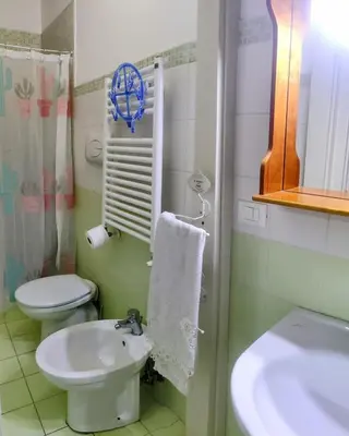 a bathroom with a toilet and a sink at Roccaforte House - Palermo in Palermo