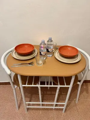 a wooden table with plates and water bottles on it at Porte Rosse in Casteldaccia