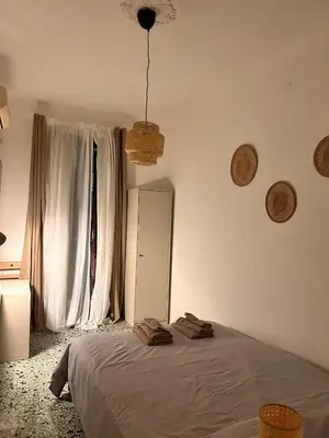 a bedroom with a bed and a window at Porte Rosse in Casteldaccia