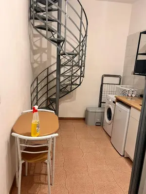 a small kitchen with a table and a drying rack at Porte Rosse in Casteldaccia
