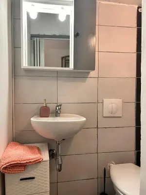 a bathroom with a sink and a mirror and a toilet at Porte Rosse in Casteldaccia