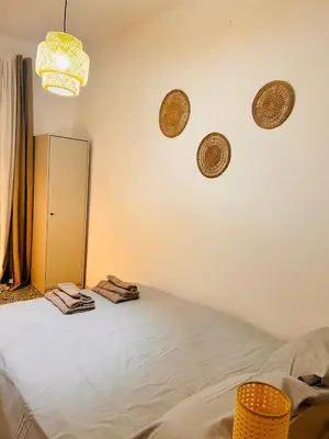 a bedroom with a bed and a mirror on the wall at Porte Rosse in Casteldaccia