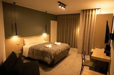 a bedroom with a bed with two towels on it at I Zingalini Affittacamere in Casteldaccia