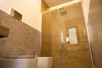 a bathroom with a shower with a glass door at I Zingalini Affittacamere in Casteldaccia