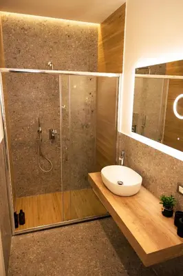 a bathroom with a shower with a sink and a toilet at I Zingalini Affittacamere in Casteldaccia