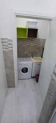 a small kitchen with a washing machine in a room at Angela apartments in Partinico