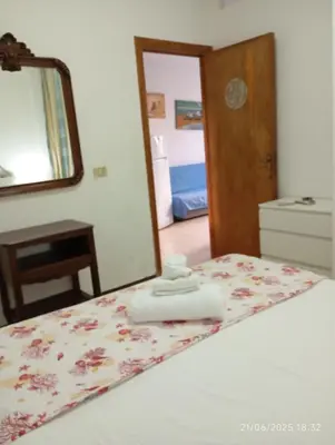 a bedroom with a bed with a mirror on it at MuSa Apartament in Balestrate