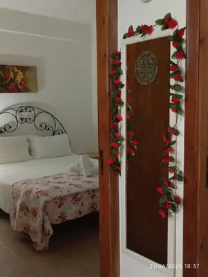a bedroom with a bed and a door with christmas decorations at MuSa Apartament in Balestrate