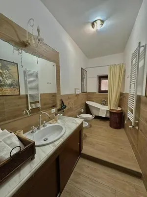 a large bathroom with a sink and a tub at Dimora Donna Carmela in Capaci
