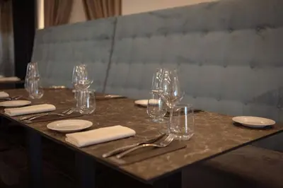 a table with wine glasses and napkins on it at Palmar Boutique Hotel in Campofelice di Roccella