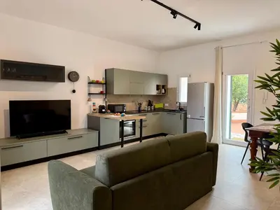 a living room with a couch and a kitchen at Casa Baglio Monti in Palermo