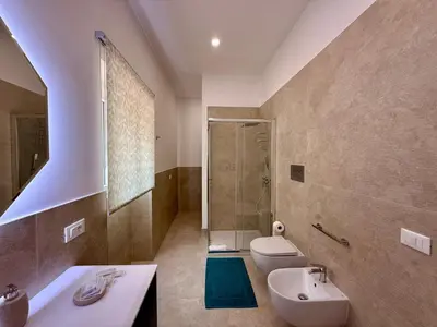 a bathroom with a sink and a toilet and a shower at Casa Baglio Monti in Palermo
