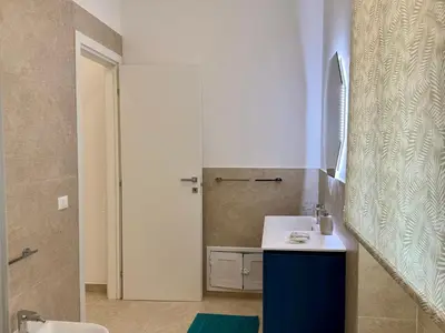 a bathroom with a blue sink and a shower at Casa Baglio Monti in Palermo