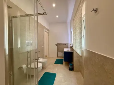 a bathroom with a shower and a toilet and a sink at Casa Baglio Monti in Palermo