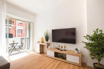 a living room with a flat screen tv on a white wall at iFlat Papi living in Palermo