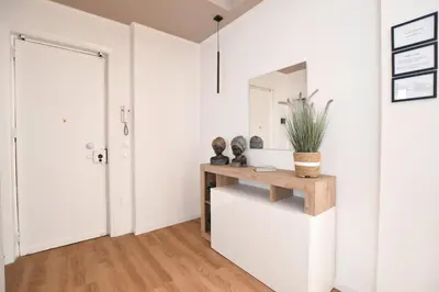 a white hallway with a table and a mirror at iFlat Papi living in Palermo