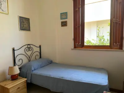 a bedroom with two twin beds and a window at Oasi Palma - Mondello in Palermo