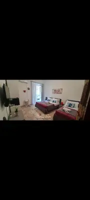 a large room with two beds and a window at Casa vacanze Andry in Cinisi