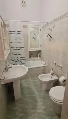 a bathroom with a sink and a toilet and a tub at Casa vacanze Andry in Cinisi
