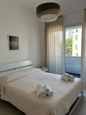 a bedroom with a white bed with towels on it at D & C Apartment in Palermo