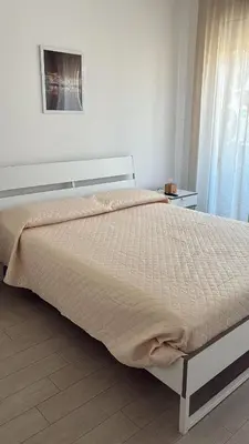 a large bed in a bedroom with a window at D & C Apartment in Palermo