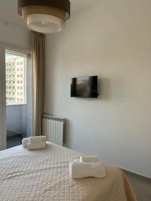 a bedroom with a bed with two towels on it at D & C Apartment in Palermo