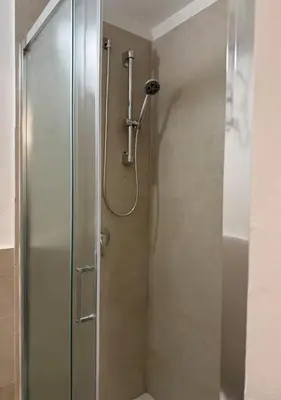 a shower with a glass door in a bathroom at DomusSolis - Casa vacanza a 2 passi dal mare in Palermo