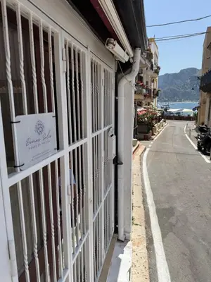 a white building with a sign on the side of a street at DomusSolis - Casa vacanza a 2 passi dal mare in Palermo