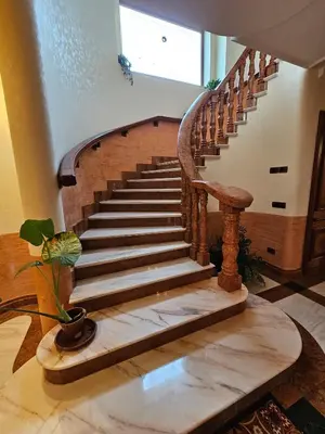 a wooden staircase in a house with a potted plant at Villa Nino in Palermo