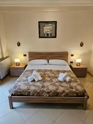 a bedroom with a large bed with two pillows at Villa Nino in Palermo