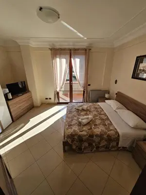 a bedroom with a bed and a large window at Villa Nino in Palermo