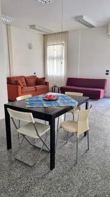a table and chairs in a room with a couch at Il Loft di Godrano in Godrano
