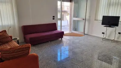a living room with a red couch and a tv at Il Loft di Godrano in Godrano
