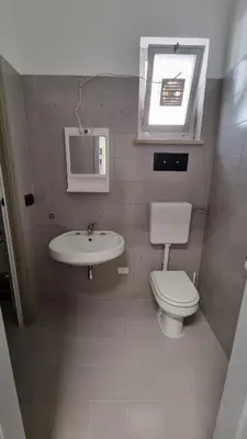a small bathroom with a toilet and a sink at Il Loft di Godrano in Godrano