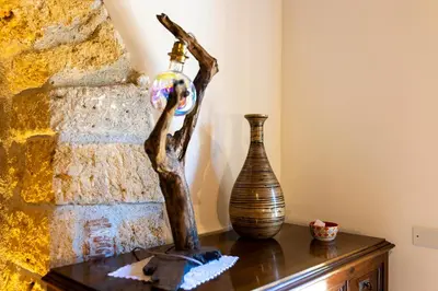 a table with two vases and a bottle on it at Villa Cannamele in Carini